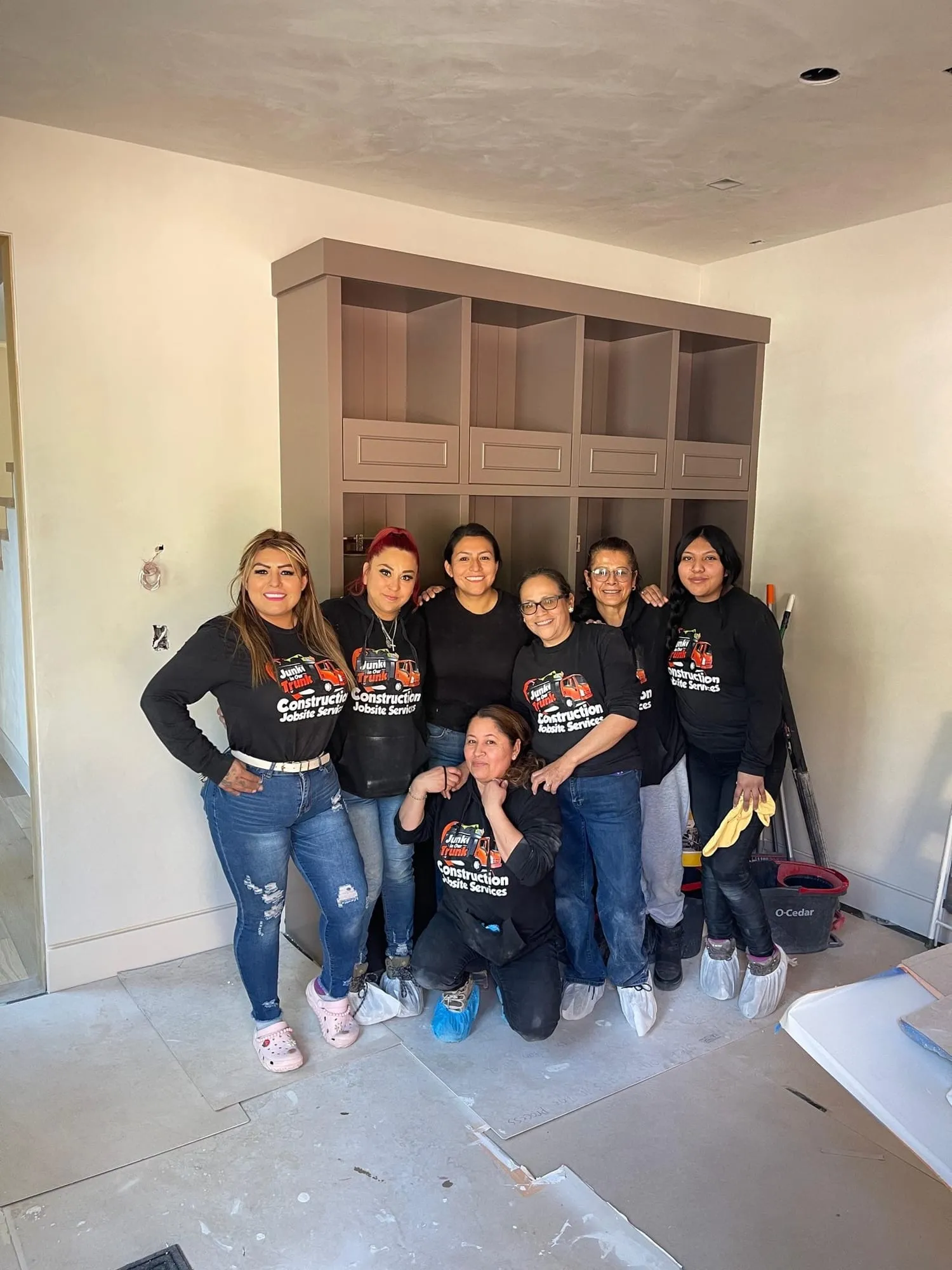 Cleaning crew posing inside a finished home