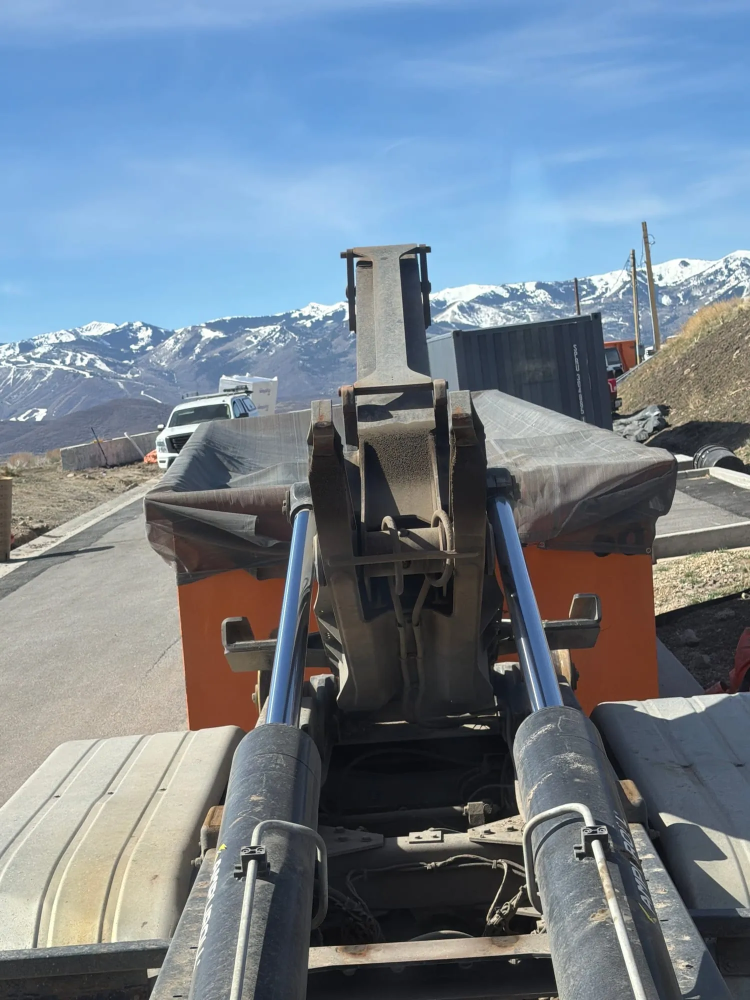 View from a Junk In Our Trunk truck's hook arm toward snowy Wasatch peaks