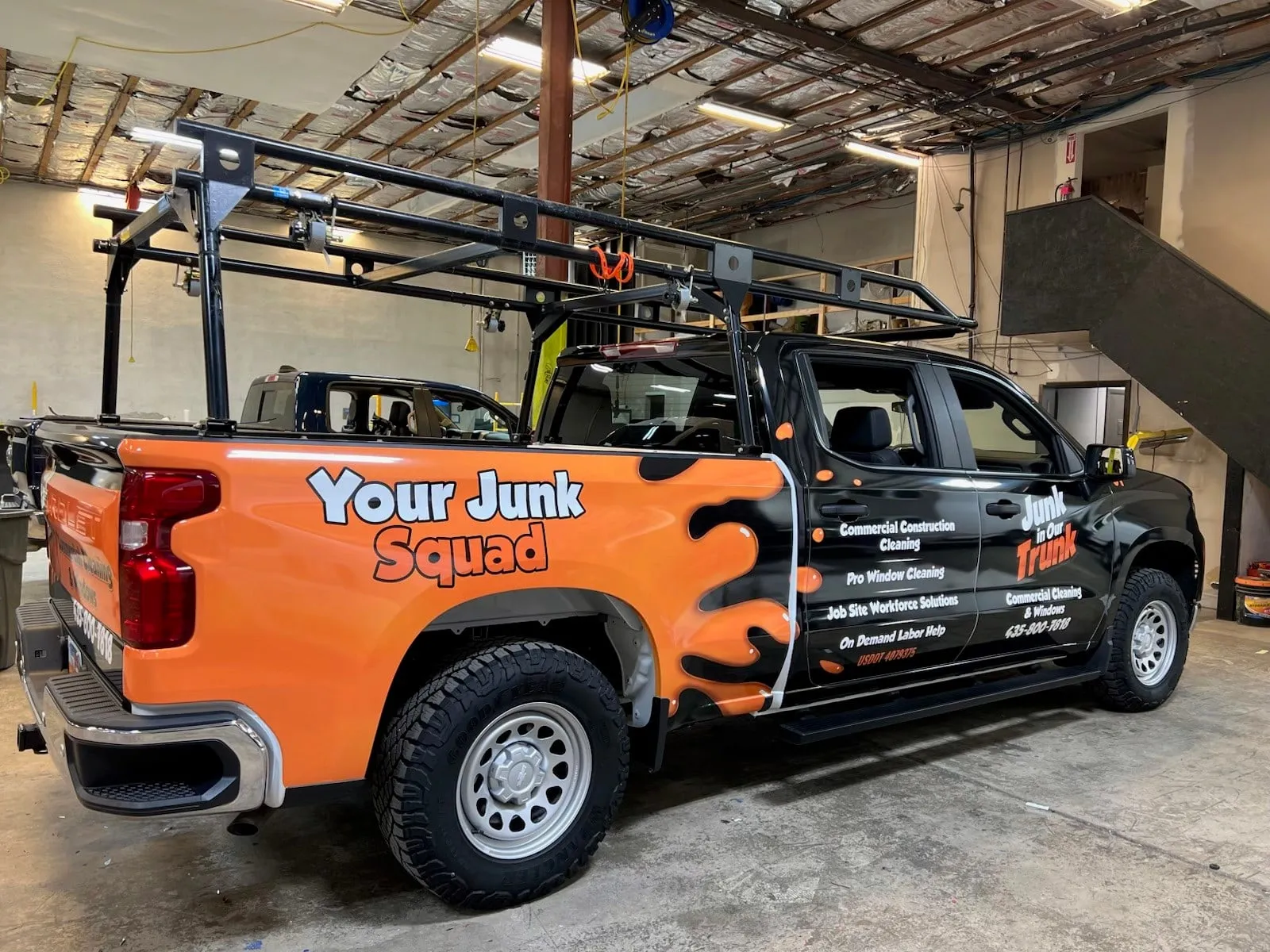 Orange Your Junk Squad pickup truck